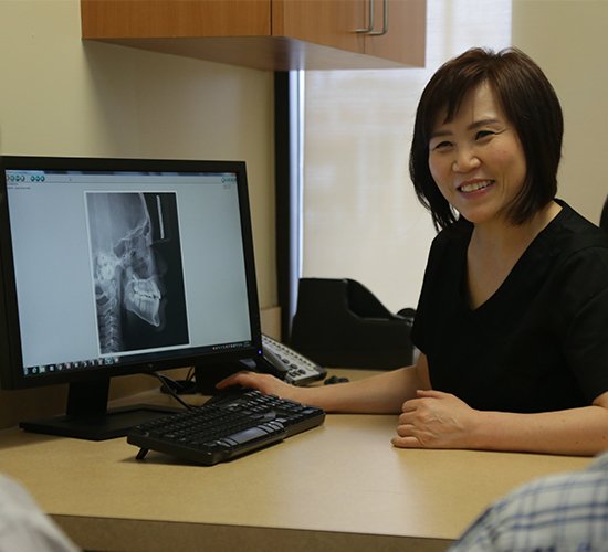Dr. Lee showing patient x-rays in consultation room