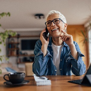 Woman smiling while talking on phone at home