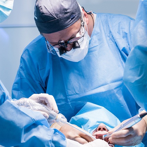 Oral surgeons performing procedure on patient’s mouth
