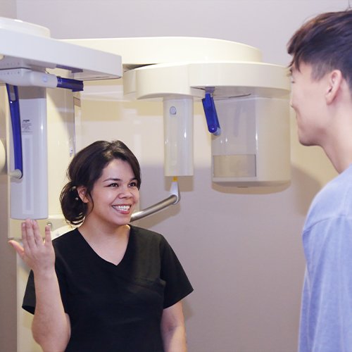 Team member showing patient 3D CT scanner