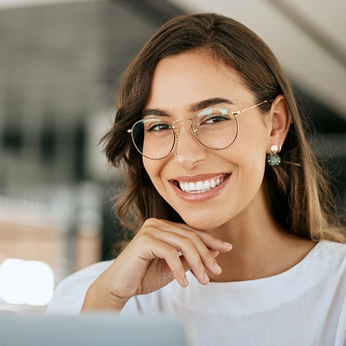 Close-up of a smiling woman with glasses