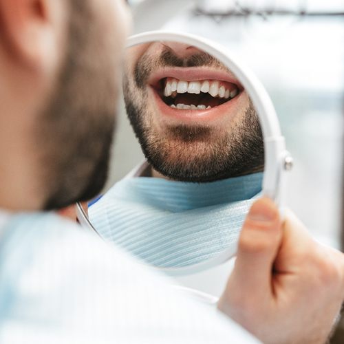 Patient looking at smile in reflection