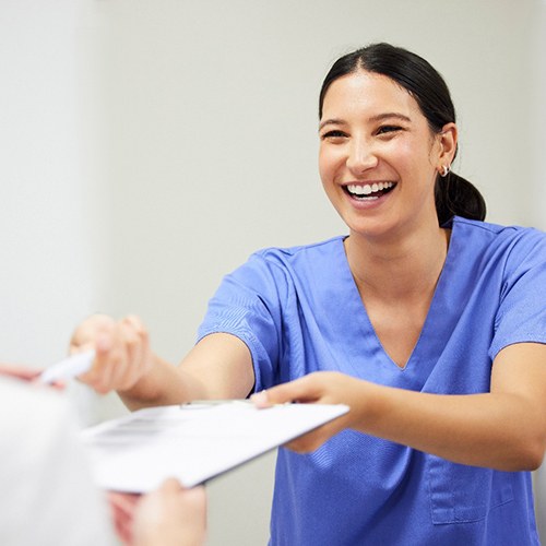 Patient in Dallas talking to dental team about dental insurance