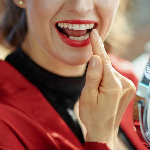 Closeup of woman with dental crown in North Dallas smiling