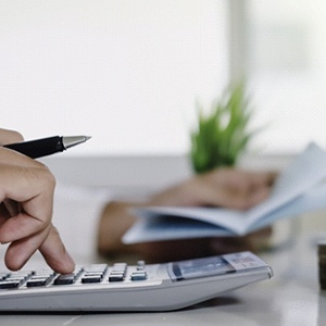 Man calculating cost of dentures in Dallas