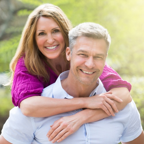 Man and woman smiling outdoors