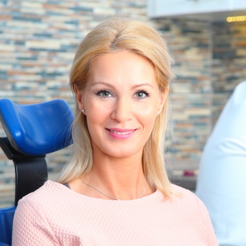 Woman in dental chair smiling