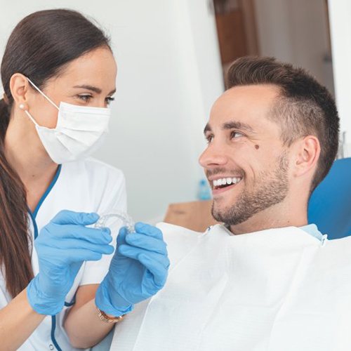 Man speaking to his North Dallas cosmetic dentist about Invisalign