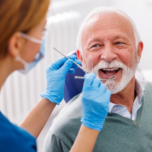 Man smiles at dentist