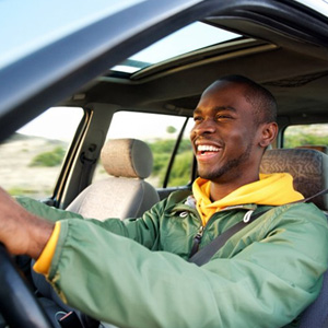 Man smiles in car
