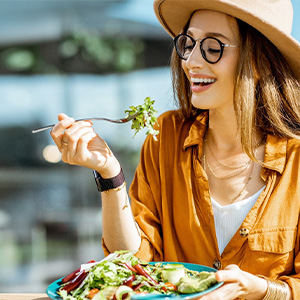 woman eating healthy to prevent dental emergencies in Dallas