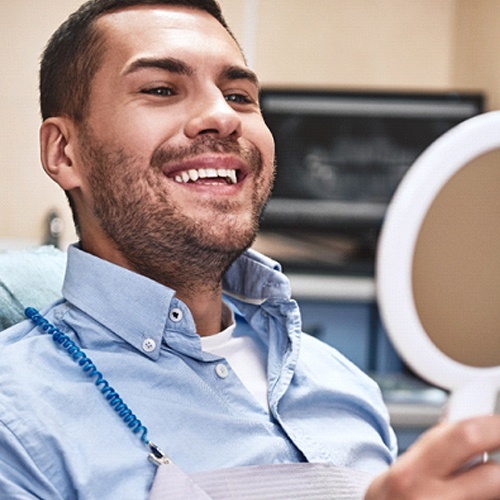 Man smiling after treating gum disease in North Dallas