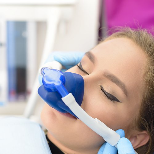 Woman with nitrous oxide nose mask