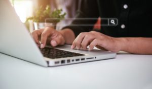 person searching for an emergency dentist in North Dallas on their laptop