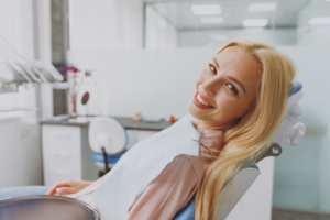 a patient smiling while visiting her dentist